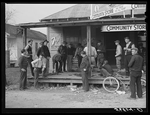 Untitled photo, possibly related to: Spanish trappers and fur buyers waiting around while muskrats are being graded during auction sale on porch of community store. Saint Bernard, Louisiana