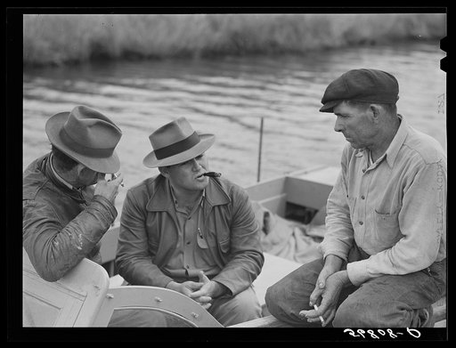 Untitled photo, possibly related to: FSA (Farm Security Administration) supervisor talking to one of the trappers in his boat by one of the bayou marsh camps. Delacroix Island, Saint Bernard Parish, Louisiana