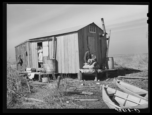 Spanish muskrat trapper's home in the marshes. In the small boats or "piroques" he can go up the very narrow and shallow bayous. Delacroix Island, Saint Bernard Parish, Louisiana