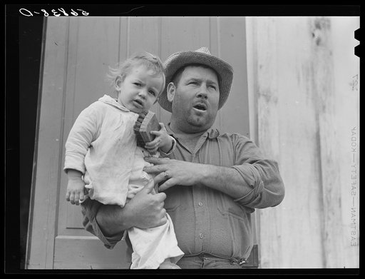 French muskrat trapper with neighbor's child. Delacroix Island, Saint Bernard Parish, Louisiana