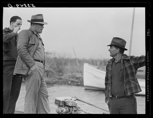 Untitled photo, possibly related to: FSA (Farm Security Administration) supervisor talking to one of the trappers in his boat by one of the bayou marsh camps. Delacroix Island, Saint Bernard Parish, Louisiana