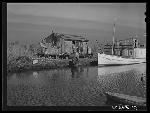 Spanish trapper's camp in the marshes. In the small "piroque" (or canoe) he can go up the very narrow and shallow bayous; the large boat he uses for fishing, going to the island to sell his muskrat pelts, and bringing back supplies. Delacroix Island, Saint Bernard Parish, Louisiana