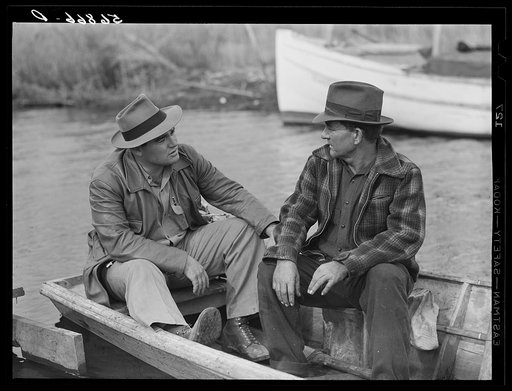 Untitled photo, possibly related to: FSA (Farm Security Administration) supervisor talking to one of the trappers in his boat by one of the bayou marsh camps. Delacroix Island, Saint Bernard Parish, Louisiana