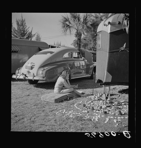 Guest at Sarasota trailer park, Sarasota, Florida, beside her garden made of shells and odds and ends. The camp has garden club for members organized for the purpose of making the surroundings attractive