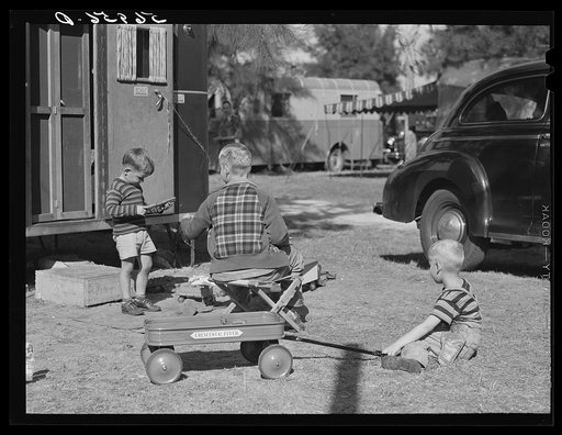 Children playing outside their trailer homes at Sarasota trailer park. Sarasota, Florida
