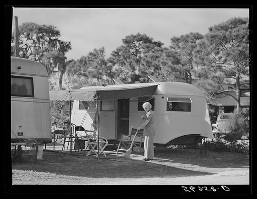 Sweeping up in front of trailer home. Sarasota trailer park, Sarasota, Florida