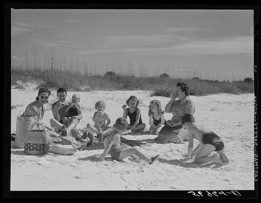 Guests of Sarasota trailer park, Sarasota, Florida, picnicking at the beach with their family and neighbor's children