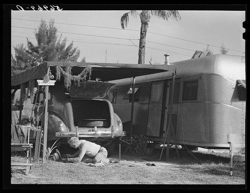 One of the guests at Sarasota trailer park, Sarasota, Florida, washing his car. He has named his trailer home "Loveless"