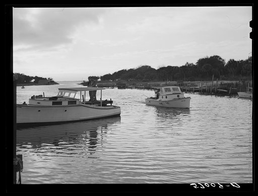 Untitled photo, possibly related to: returning from fishing, guests of Sarasota trailer park glide into docks. Sarasota, Florida