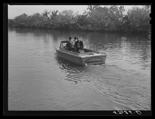 Three FSA (Farm Security Administration) supervisors going out the bayous and marshes to some of the muskrat trappers at their camps. Near Delacroix Island, Louisiana