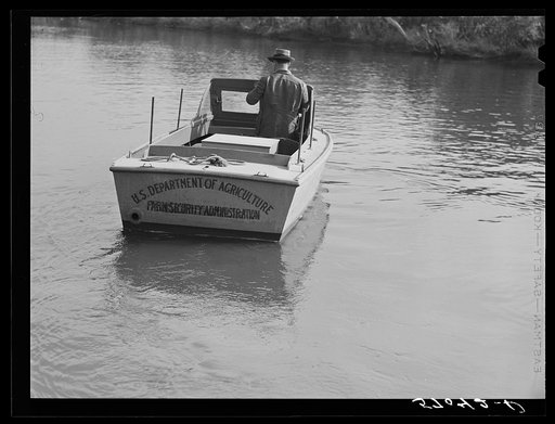 FSA (Farm Security Administration) supervisor going out in the bayous and marshes to visit some of the muskrat trappers at their canps. Near Delacroix Island, Louisiana