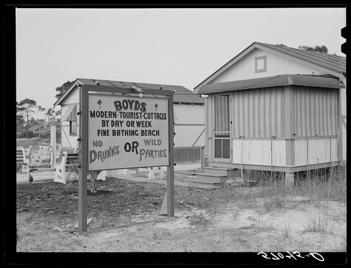 Sign advertising tourist cottages on highway outside Pensacola, Florida
