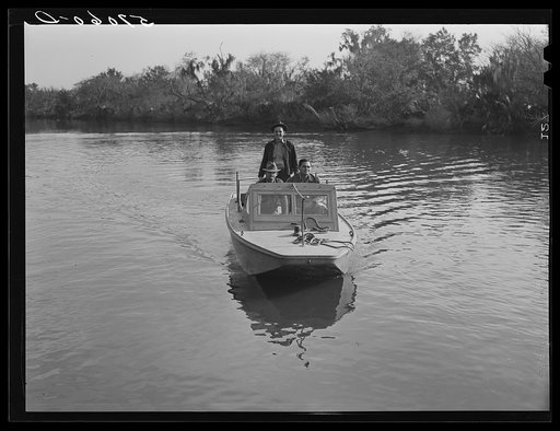 Three FSA (Farm Security Administration) supervisors going out in the bayous and marshes to visit some of the muskrat trappers at their camp. Near Delacroix Island, Louisiana. See general caption number one