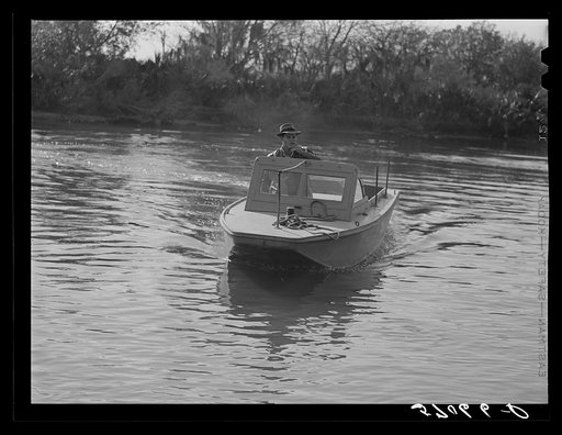 Weldon P. Smith, FSA (Farm Security Administration) supervisor, going out to the bayous and marshes to visit some of the muskrat trappers at their camps. Near Delacroix Island, Louisiana. See general caption number one