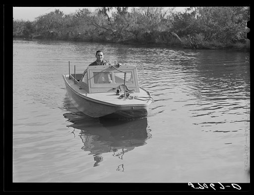 Weldon P. Smith, FSA (Farm Security Administration) supervisor, going out to the bayous and marshes to visit some of the muskrat trappers at their camps. Near Delacroix Island, Louisiana. See general caption number one