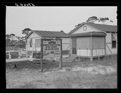 Untitled photo, possibly related to: Sign advertising tourist cottages on highway outside Pensacola, Florida