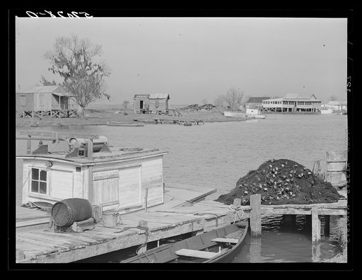 Trappers' and fishermen's boats and homes along the bayou. Delacroix Island, Louisiana