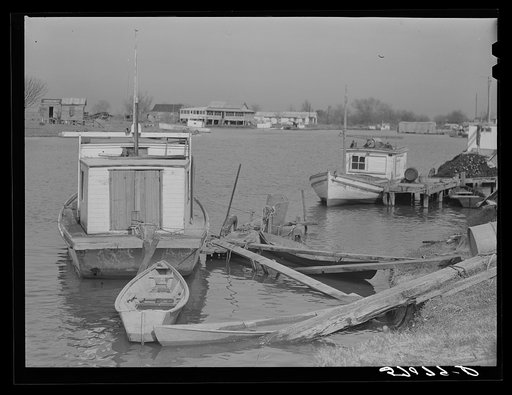 Trappers' and fishermen's boats and homes along the bayou. Delacroix Island, Louisiana