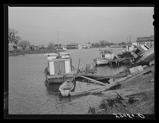 Trappers' and fishermen's boats and homes along the bayou. Delacroix Island, Louisiana