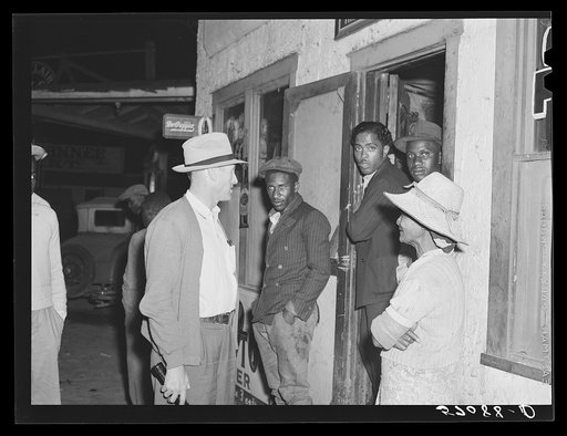 John Kirk maintaining the law and checking up on Saturday night in the Negro quarter of Belle Glade, Florida