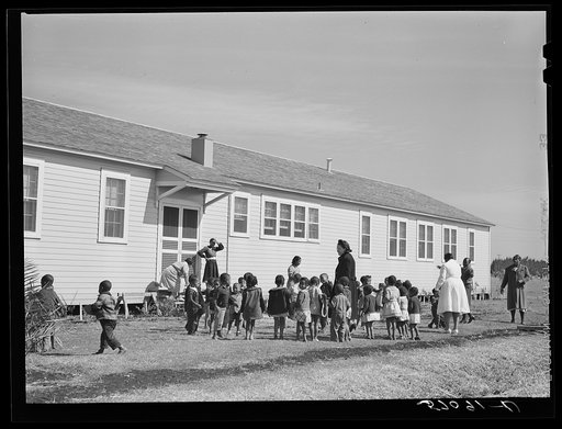 Negro childen playing outside of nursey at Okeechobee migratory labor camps built by FSA (Farm Security Administration). Belle Glade, Florida
