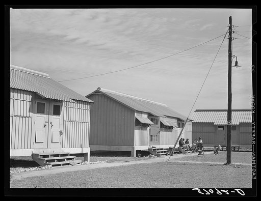 Metal shelters for migratory vegetable pickers. Okeechobee migratory labor camps built by FSA (Farm Security Administration). Belle Glade, Florida