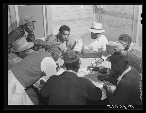 Migratory laborers and vegetable pickers playing "skin" game in back of juke joint and bar in the Belle Glade area of south central Florida