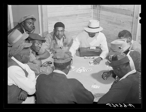 Migratory laborers and vegetable pickers playing "skin" game in back of juke joint and bar in the Belle Glade area of south central Florida