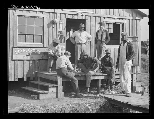 Migratory laborers playing checkers in front of juke joint during slack season for vegetable pickers. Belle Glade, Florida
