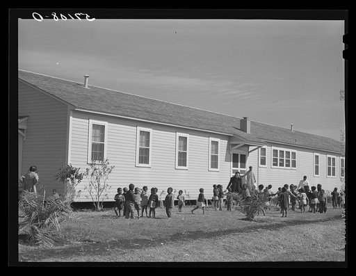 Negro children playing outside of nursery at Okeechobee migratory labor camps built by FSA (Farm Security Administration). Belle Glade, Florida