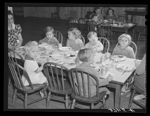 Children of migratory workers eating lunch in twenty-four hour nursery at Osceola migratory labor camp built by FSA (Farm Security Administration). Belle Glade, Florida