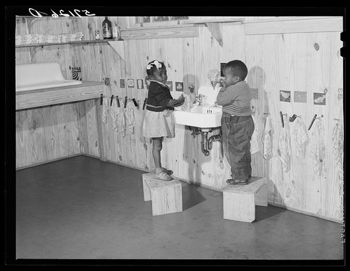 Agricultural workers' children washing up before a hot lunch in day nursery at Okeechobee migratory labor camp. Belle Glade, Florida