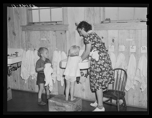Children of agricultural and packing house workers washing up before getting a hot lunch in twenty-four hour a day nursery at Osceola migratory labor camp. Belle Glade, Florida