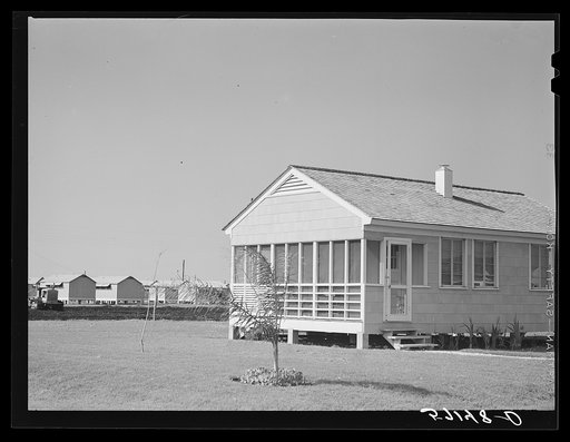 Labor home with metal shelters in background for agricultural workers. Osceola migratory labor camp, Belle Glade, Florida