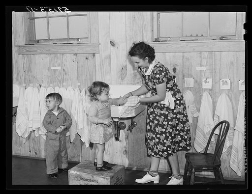 Children of agricultural and packing house workers washing up before getting a hot lunch in twenty-four hour a day nursery at Osceola migratory labor camp. Belle Glade, Florida