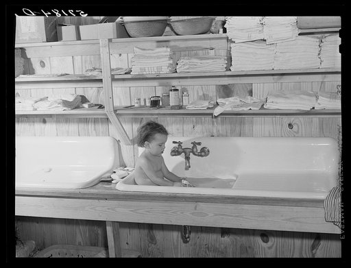 Agricultural worker's child taking a bath in the twenty-four hour a day nursery at Osceola migratory labor camp. Belle Glade, Florida