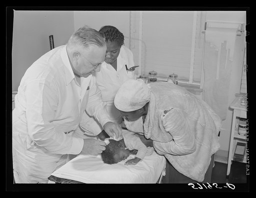 Dr. William Buck treating migratory worker's child in clinic. Okeechobee migratory labor camp, Belle Glade, Florida