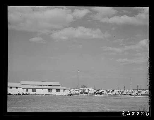 General view, community building, utilities and metal shelters for agricultural workers at Osceola migratory labor camp. Belle Glade, Florida
