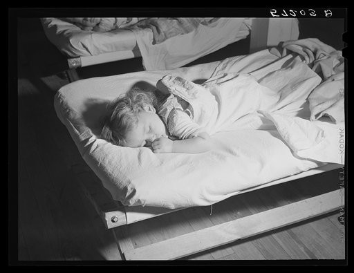 Child of agricultural and packing house worker taking rest hour in twenty-four hour a day nursery at Osceola migratory labor camp. Belle Glade, Florida