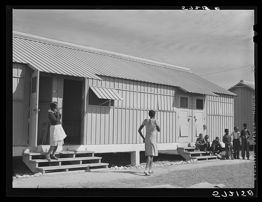 Metal shelters for agricultural workers in Okeechobee migratory labor camp. Belle Glade, Florida