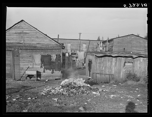 "Hotel" Pahokee for Negro migratory laborers. Garbage in foreground. Pahokee, Florida
