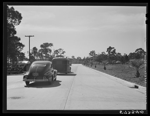 Trailer and cars along road to Sarasota trailer park. Sarasota, Florida