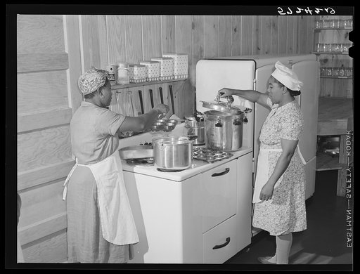 Preparing hot lunch for agricultural workers' children in kitchen of day nursery. Okeechobee migratory labor camp, Belle Glade, Florida