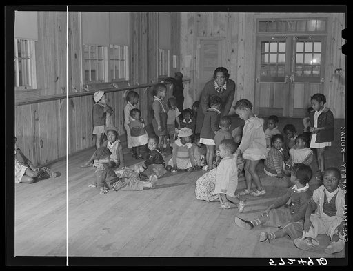 Children of agricultural workers in the day nursery waiting for their mothers to take them home in the evening. Okeechobee migratory labor camp, Belle Glade, Florida