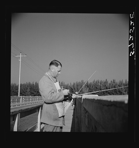 Guest of Sarasota trailer park, Sarasota, Florida, adjusting fishing rod