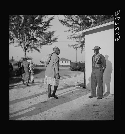 Taking supplies home from surplus commodities. Belle Glade, Florida