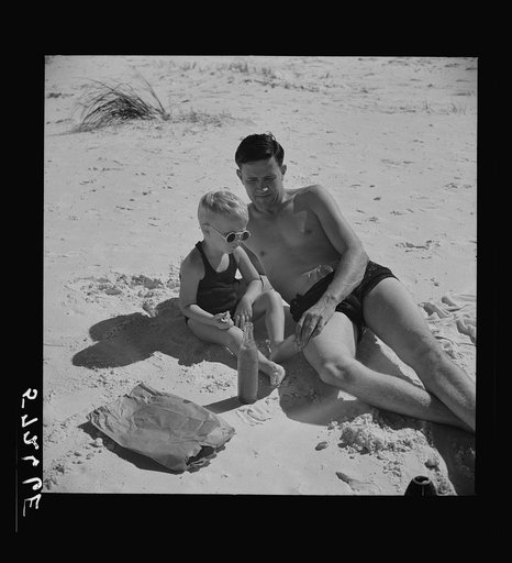 Untitled photo, possibly related to: Guest of Sarasota trailer park, Sarasota, Florida, with his family, picnicking at the beach