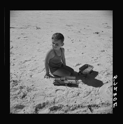 Son of parents who live at Sarasota trailer park, Sarasota, Florida, playing on the beach