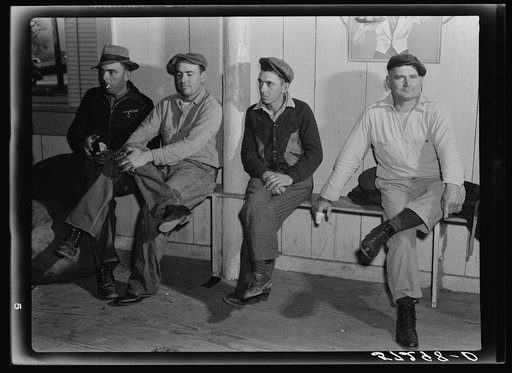 Spanish muskrat trappers waiting in dance hall during fur auction sale. Delacroix Island, Louisiana