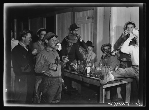 Spanish muskrat trappers have a round of drinks after each lot is sold at the fur auction held in a dance hall on Delacroix Island, Louisiana